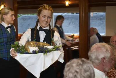 Kellnerin serviert beim Galas-Dinner auf der MS Lord of the Highlands